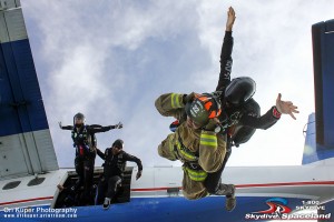 Houston Fire Department firefighter Chris Lee exits the plane for the memorial jump with Jason Hyder. 