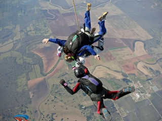 Houston mayor Annise Parker skydiving with instructor Hank Prewitt and Helaine Rumaner