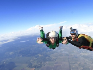 Your instructor will keep a grip on you while you learn to maintain a stable freefall body position, giving hand signals for corrections if needed.