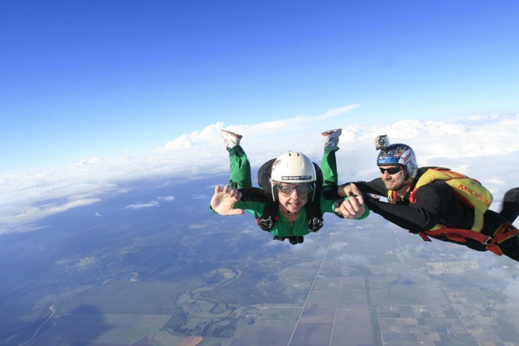 Your instructor will keep a grip on you while you learn to maintain a stable freefall body position, giving hand signals for corrections if needed.