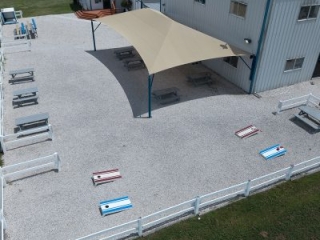 Skydive Spaceland San Marcos: Spectator Area with shade, picnic tables, cornhole games, and bleachers Skydive Spaceland San Marcos: Spectator Area with shade, picnic tables, cornhole games, and bleachers